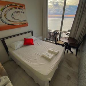 a bedroom with a bed with a view of the ocean at Hotel Pousada Brisa Mar in Salvador