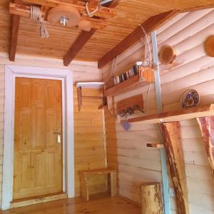 a room with a door in a wooden cabin at Kostel House in Mykulychyn