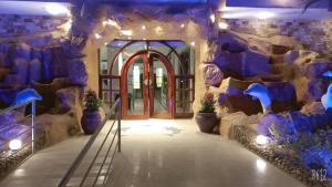 a lobby with a stone wall and a door at Dolphin Continental Hotel in Quseir
