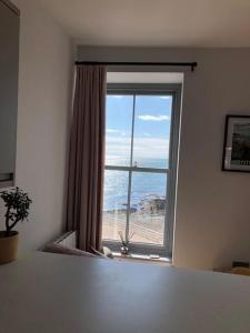 a room with a window with a view of the ocean at Sea View Apartment - Sleeps 2 in Aberystwyth