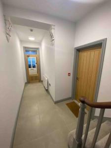 an empty hallway with two doors and a stairway at Sea View Apartment - Sleeps 2 in Aberystwyth