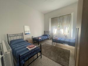 A bed or beds in a room at Nuova Casa vacanze nonna Prassede con giardino e posto auto