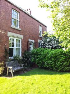 a bench sitting in front of a brick building at Bed and Breakfast Ashfield in Pocklington