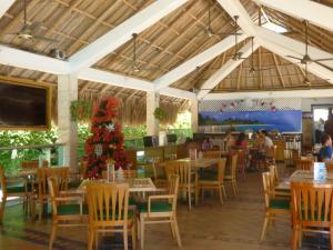 a restaurant with tables and chairs and a christmas tree at Costa Azul Suites 403 in Santa Marta
