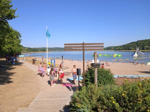 a group of people walking on a beach at Les Jardins des 3 Provinces- Gîte in Montcharvot