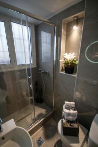 a bathroom with a shower and a toilet and a sink at Sea View luxury apartment in Volos