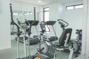 a gym with treadmills and elliptical machines at Aquarius Hotel Flat Residence in Santa Cruz do Sul