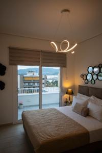 a bedroom with a large bed and a large window at Sea View luxury apartment in Volos