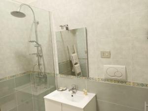 a bathroom with a sink and a shower with a mirror at UltimoCasale in Matera +34 photos