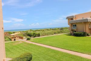 a view of a house with a lawn and the ocean at Creston House 2D in St. Augustine