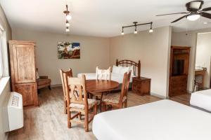 a dining room with a table and chairs and a bedroom at Aarchway Inn in Moab