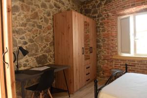 a room with a bed and a cabinet and a desk at Apartamentos Tierra y Arte in Santoña
