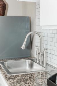 a kitchen sink with a faucet on a counter at Aarchway Inn in Moab