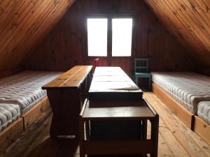 a room with two beds in a wooden cabin at Chata Florián in Stráž