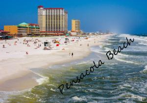 a beach with a sign that reads at Navarre Beach Escapades-Pet Friendly in Navarre