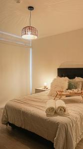 a bedroom with a large bed with towels on it at Chic Executive Apartment-Barranco in Lima