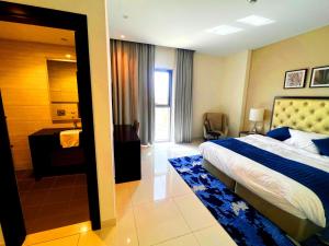 a hotel room with a bed and a bathroom at Lovely one bedroom apartment with world class hotel amenities in Dubai