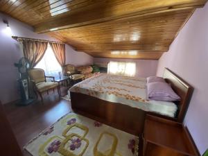 a bedroom with a large bed with a wooden ceiling at Balcı Apart in Çanakkale