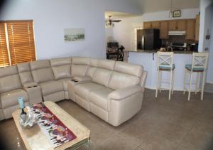a living room with a couch and a kitchen at Navarre Beach Escapades in Navarre