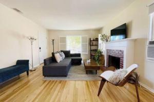 a living room with a couch and a fireplace at Spacious family oasis in silicon beach 5mins to LAX in Los Angeles