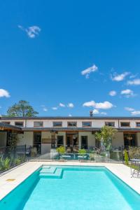 a swimming pool in front of a building at Antria Boutique Lodge in Blenheim