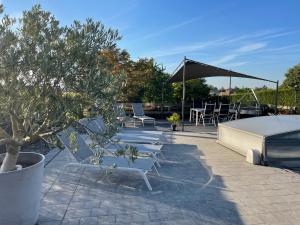 a patio with chairs and a table and an umbrella at Guest house Time to Escape in Meise