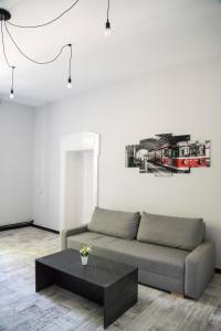 a living room with a couch and a table at Apartament "Przy Dworcu" in Chojnice
