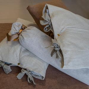 a pillow with a bow on top of it at LA S'VOLTA VANZAGO BED AND BREAKFAST in Vanzago