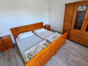 a small bedroom with two beds and a dresser at Luketovi in Kostanjevica na Krasu
