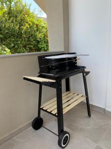 a grill sitting on a table in front of a window at Beautiful House in Front of the Sea in Gázion