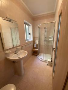 uma casa de banho com um lavatório e um chuveiro em Newly Refurbished Mellieha Central apartment em Mellieħa