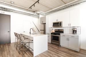 a kitchen with white cabinets and a counter top at Sonder The Opal in Chicago