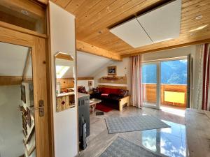 a kitchen and living room with a refrigerator and a couch at Chalet Magda in Heiligenblut