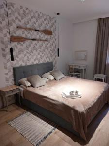 a bedroom with a bed with tongs on it at Apartament Prima in Lubniewice