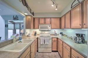 a kitchen with wooden cabinets and a stove top oven at All-Season Base! Unit w/ Balcony in Beech Mountain in Beech Mountain