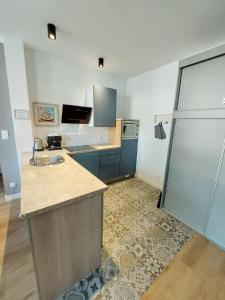 a large kitchen with a sink and a shower at Apartament Prima in Lubniewice