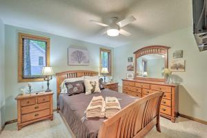 a bedroom with a bed and a dresser and a mirror at All-Season Base! Unit w/ Balcony in Beech Mountain in Beech Mountain