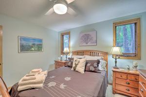 a bedroom with a bed and a dresser and two windows at All-Season Base! Unit w/ Balcony in Beech Mountain in Beech Mountain