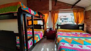 1 dormitorio con 2 literas y ventana en Posada Rural - La Isabela, en Tópaga