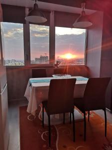 a dining room with a table and chairs and a sunset at EL VERANO VARNA in Varna City