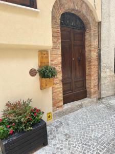 a door of a building with two potted plants at B&B Vico Suites in Vico nel Lazio