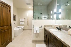 a large bathroom with a tub and a sink and a tubermott at Luxury One Bedroom with Mountain View apartment hotel in Park City