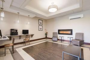 an empty waiting room with chairs and a fireplace at Best Western Northwest Indiana Inn in Hammond