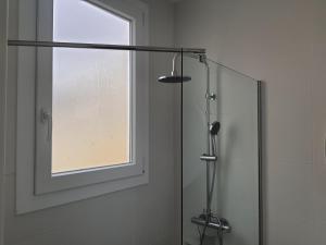 a shower in a bathroom with a window at Exotic Fusion: Coffee & Radio in Lisbon