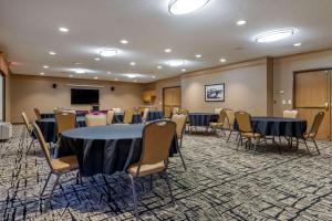 a conference room with tables and chairs and a screen at Best Western Plus Chelsea Hotel in Monticello