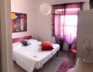 A bed or beds in a room at Casa Tognetti Affittacamere