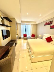 a large hotel room with a bed and a television at A cozy apartment at Sandton Skye in Johannesburg