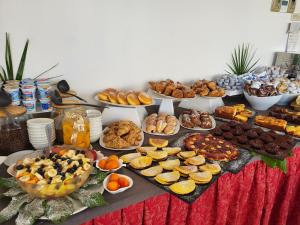 a table topped with lots of different types of food at Hotel Giannini in Rimini