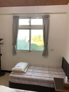Postel nebo postele na pokoji v ubytování Dongyin Homestay連江縣民宿054號