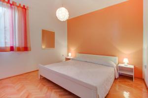 - une chambre avec un lit et deux lampes sur deux tables dans l'établissement Apartment Mali Losinj 7879d, à Mali Lošinj